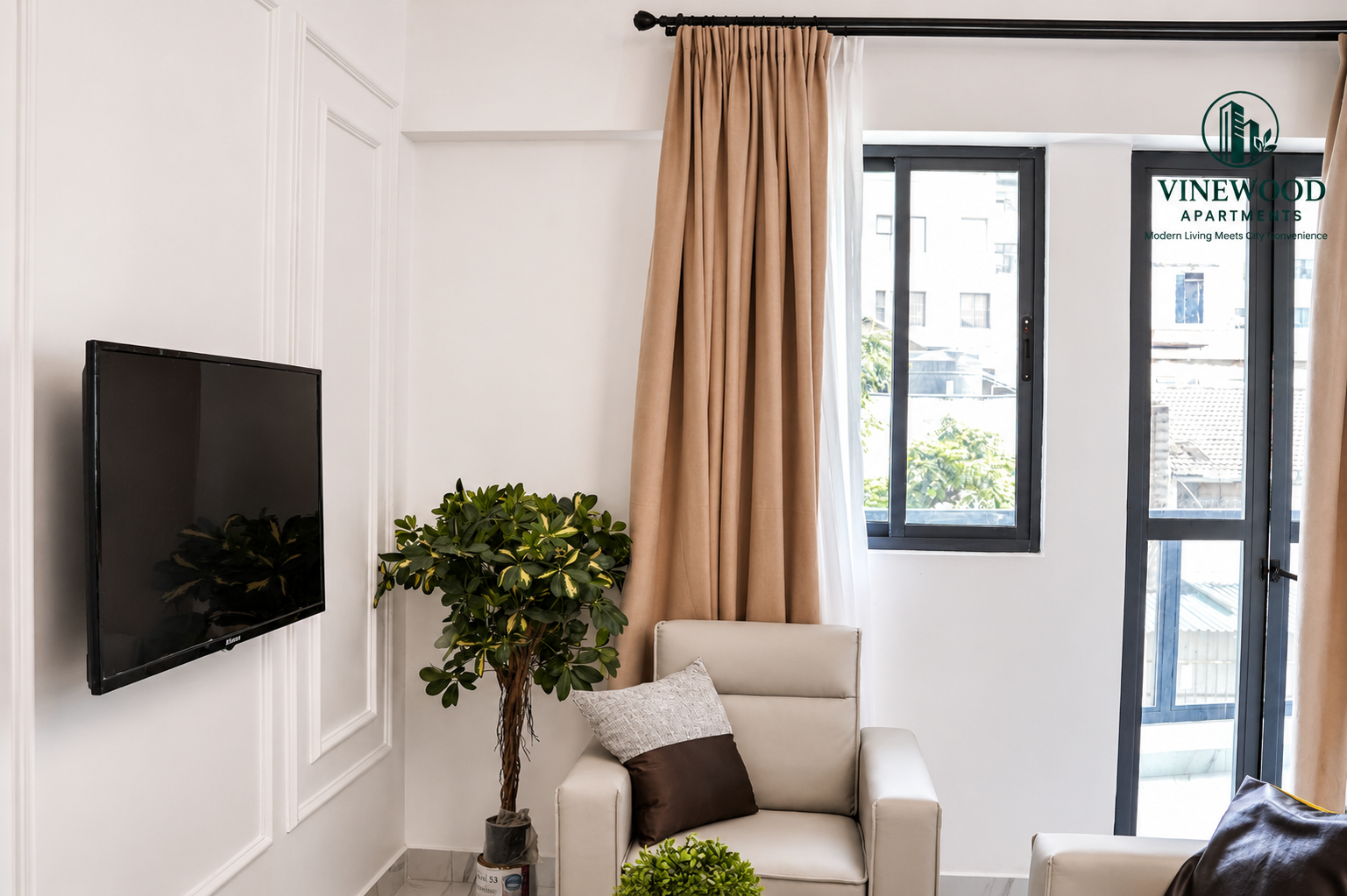 Bright sitting area with balcony view at VineWood Apartments